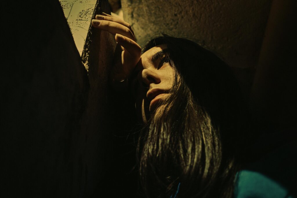 Artistic portrait of a woman's face in dramatic lighting, evoking emotion.