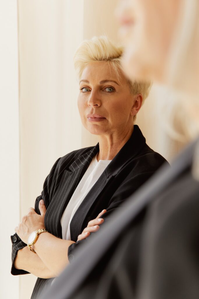 Sophisticated adult woman with short hair poses indoors with elegance and confidence.